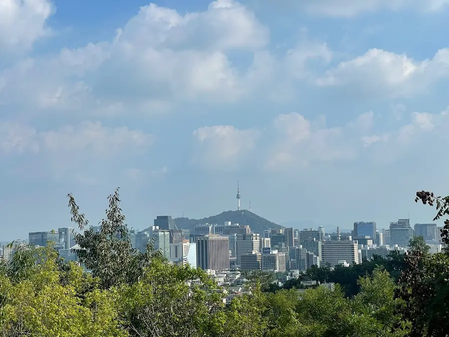 Summer skyline of Seoul viewed from Bukaksan Mountain during an urban hike