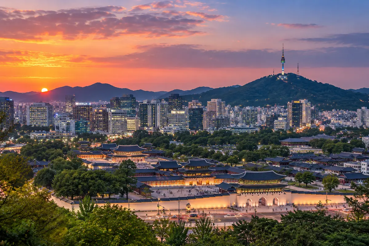 Seoul skyline with traditional palace and N Seoul Tower at sunset